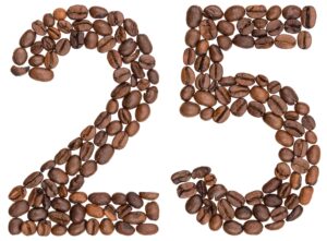 The number 25 formed by arranging brown coffee beans on a white background, perfect for sharing interesting coffee facts. Top Dose Roasters